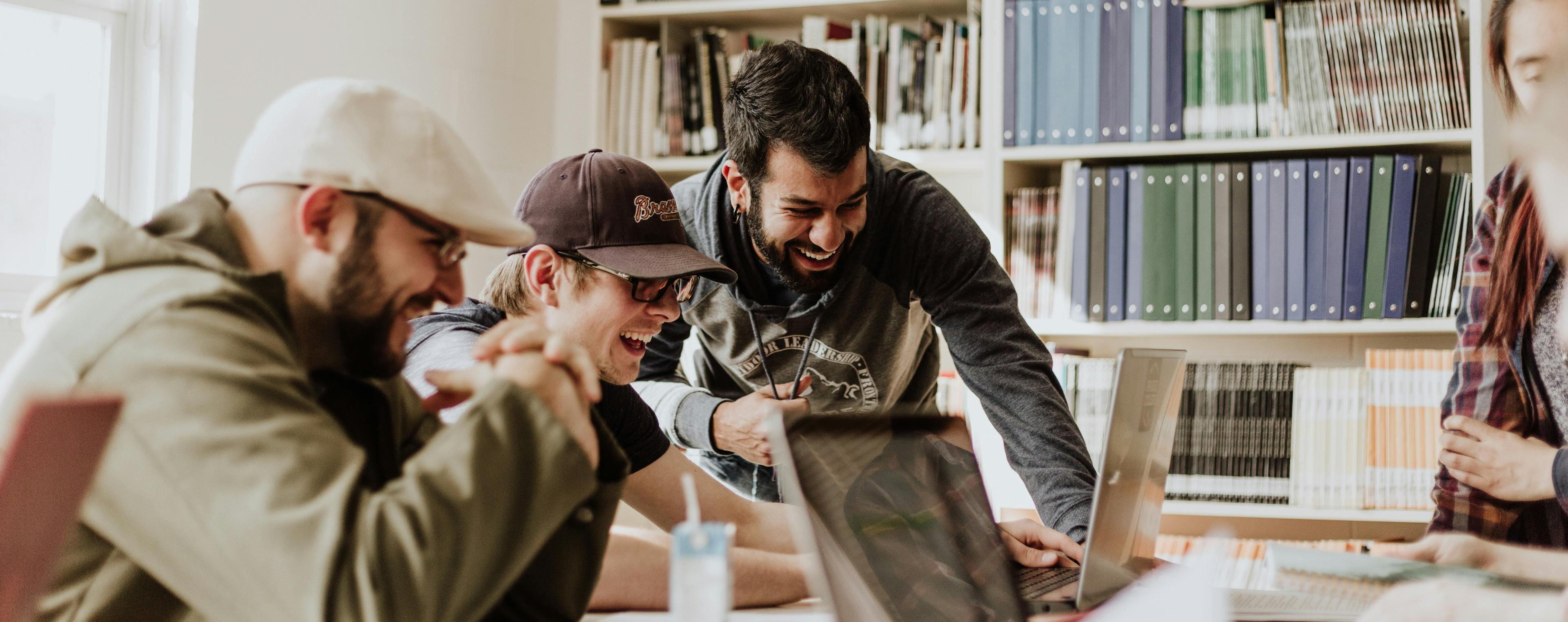 Team gathered around a computer working on tech marekting rebrand activities