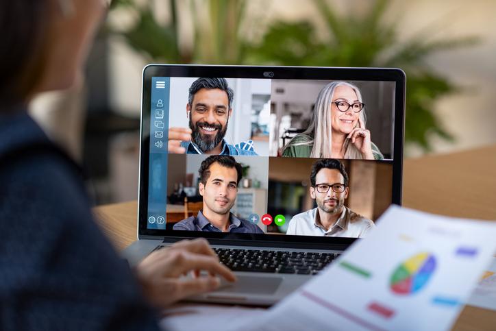 a laptop that a zoom meeting on the screen