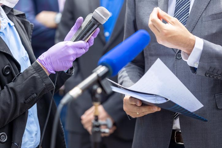 close up of reporter and interviewee talking to each other