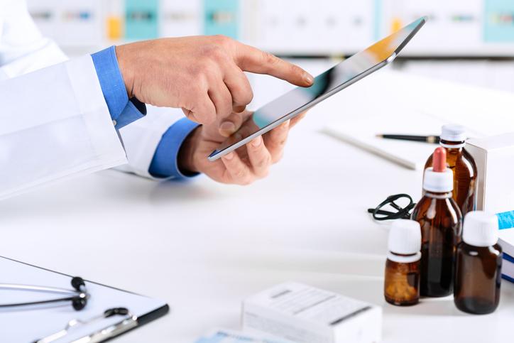 healthcare provider working on tablet.